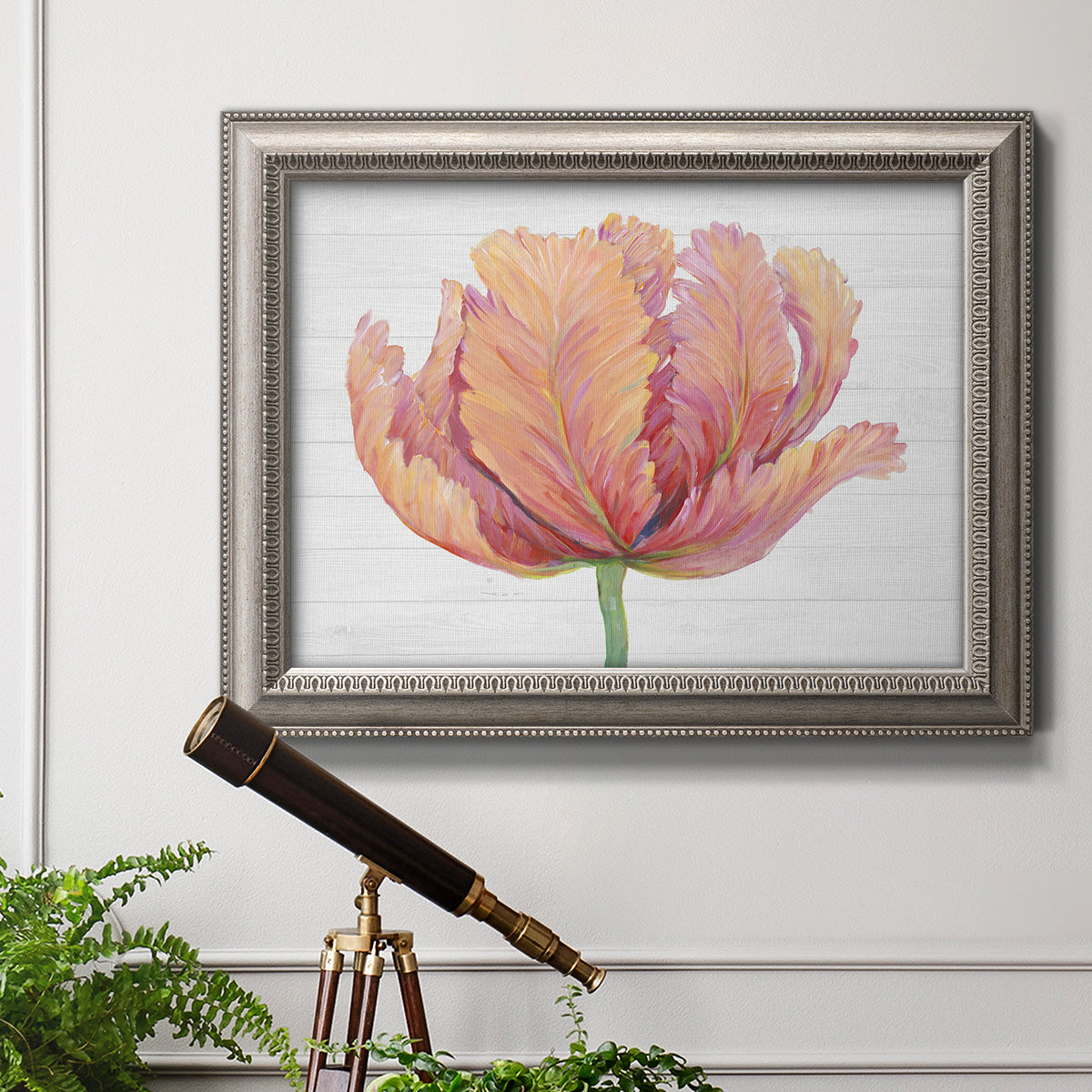 Minimalist pink flower abstract artwork in an ornate vintage silver frame displayed in a light-toned interior setting.