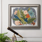 Colorful eclectic botanical artwork in an ornate vintage silver frame displayed in a light-toned interior setting.