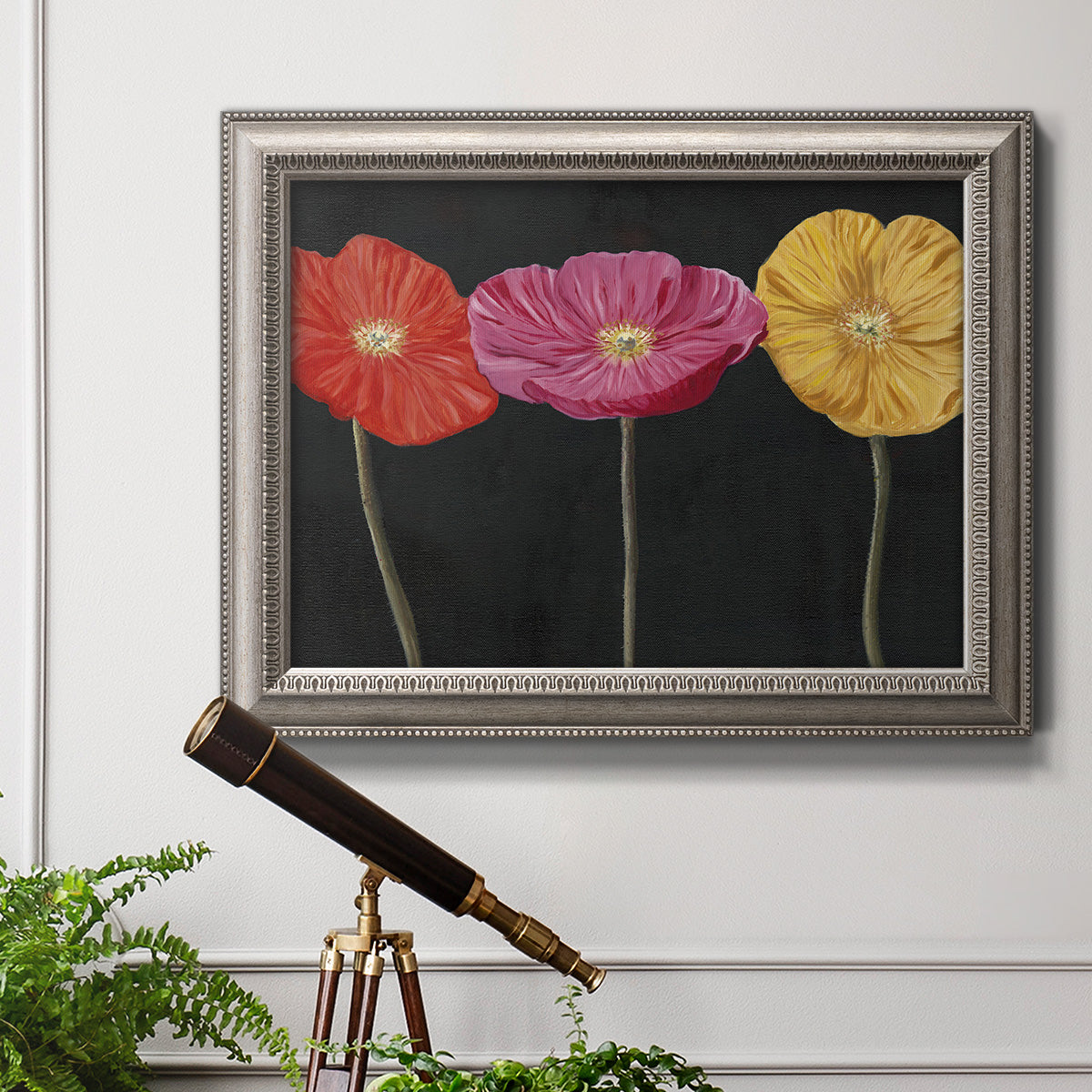 Contemporary poppy flower artwork in an ornate vintage silver frame displayed in a light-toned interior setting.