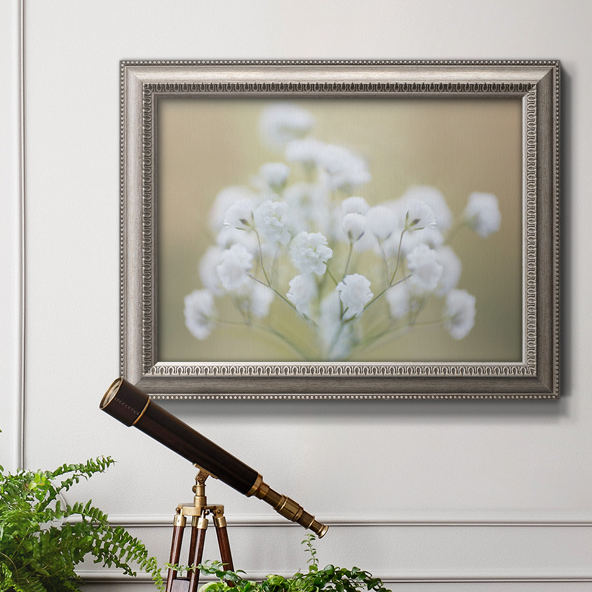 Botanical baby’s breath flower photography in an ornate vintage silver frame displayed in a light-toned interior setting.