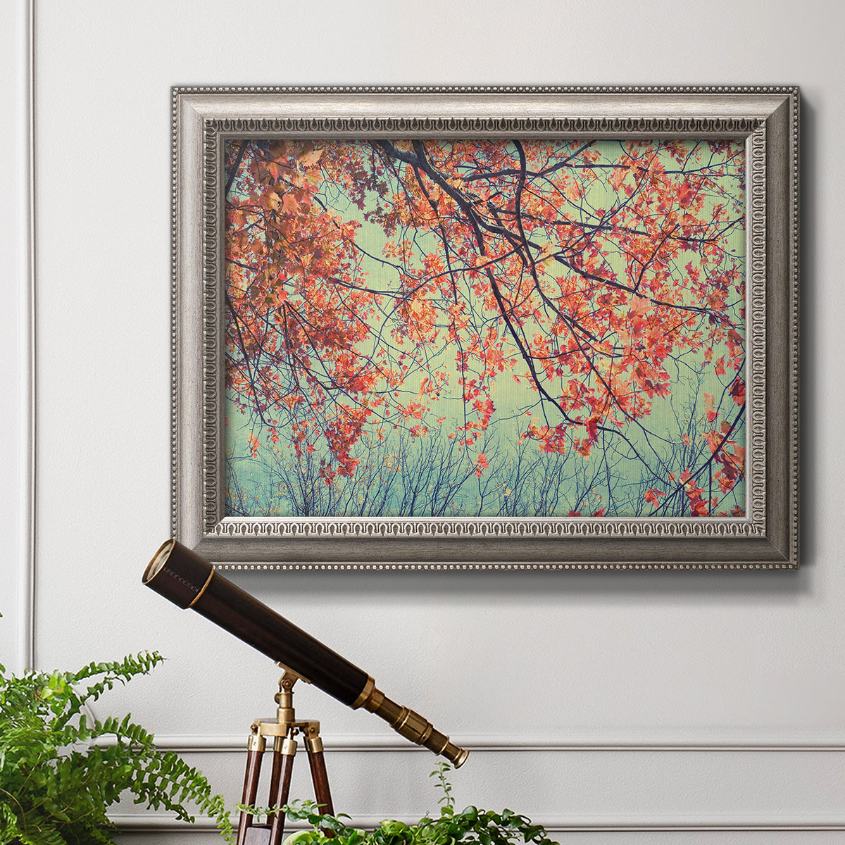 Eclectic fall floral landscape artwork in an ornate vintage silver frame displayed in a light-toned interior setting.
