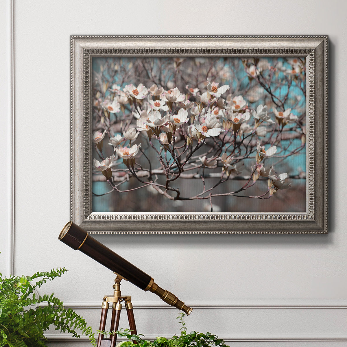 Modern spring dogwood flower photograph in an ornate vintage silver frame displayed in a light-toned interior setting.
