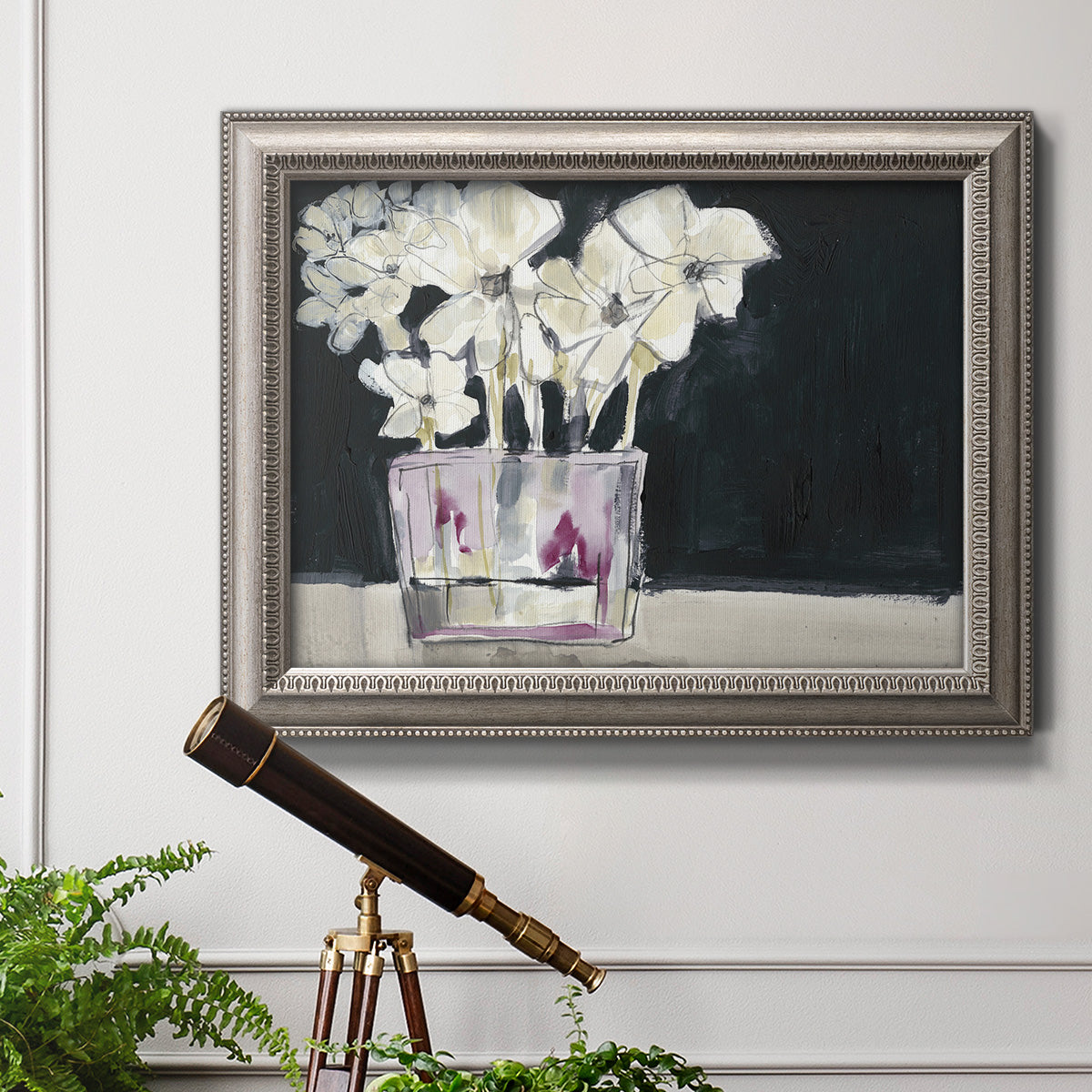 Contemporary floral watercolor with white flowers in an ornate vintage silver frame displayed in a light-toned interior setting.