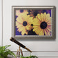 Contemporary yellow Susan floral photograph in an ornate vintage silver frame displayed in a light-toned interior setting.