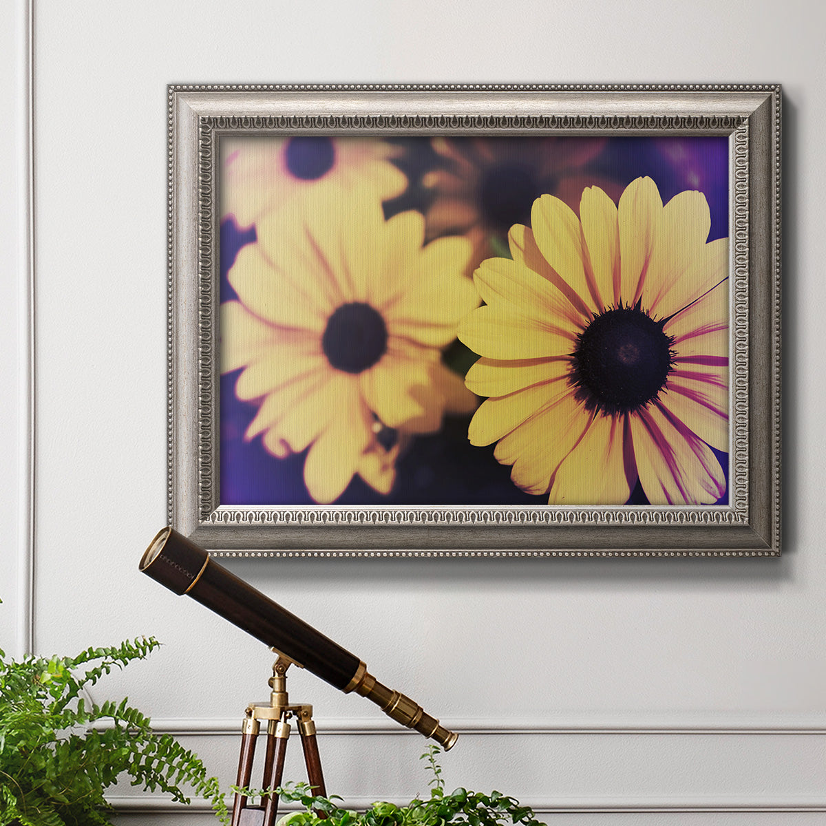 Contemporary yellow Susan floral photograph in an ornate vintage silver frame displayed in a light-toned interior setting.