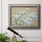 Delicate baby’s breath floral photograph in an ornate vintage silver frame displayed in a light-toned interior setting.