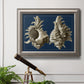 Vintage nautical conch shell artwork on navy background in an ornate vintage silver frame displayed in a light-toned interior setting.