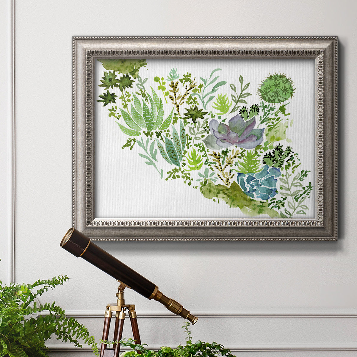 Contemporary abstract succulent botanical watercolor in an ornate vintage silver frame displayed in a light-toned interior setting.