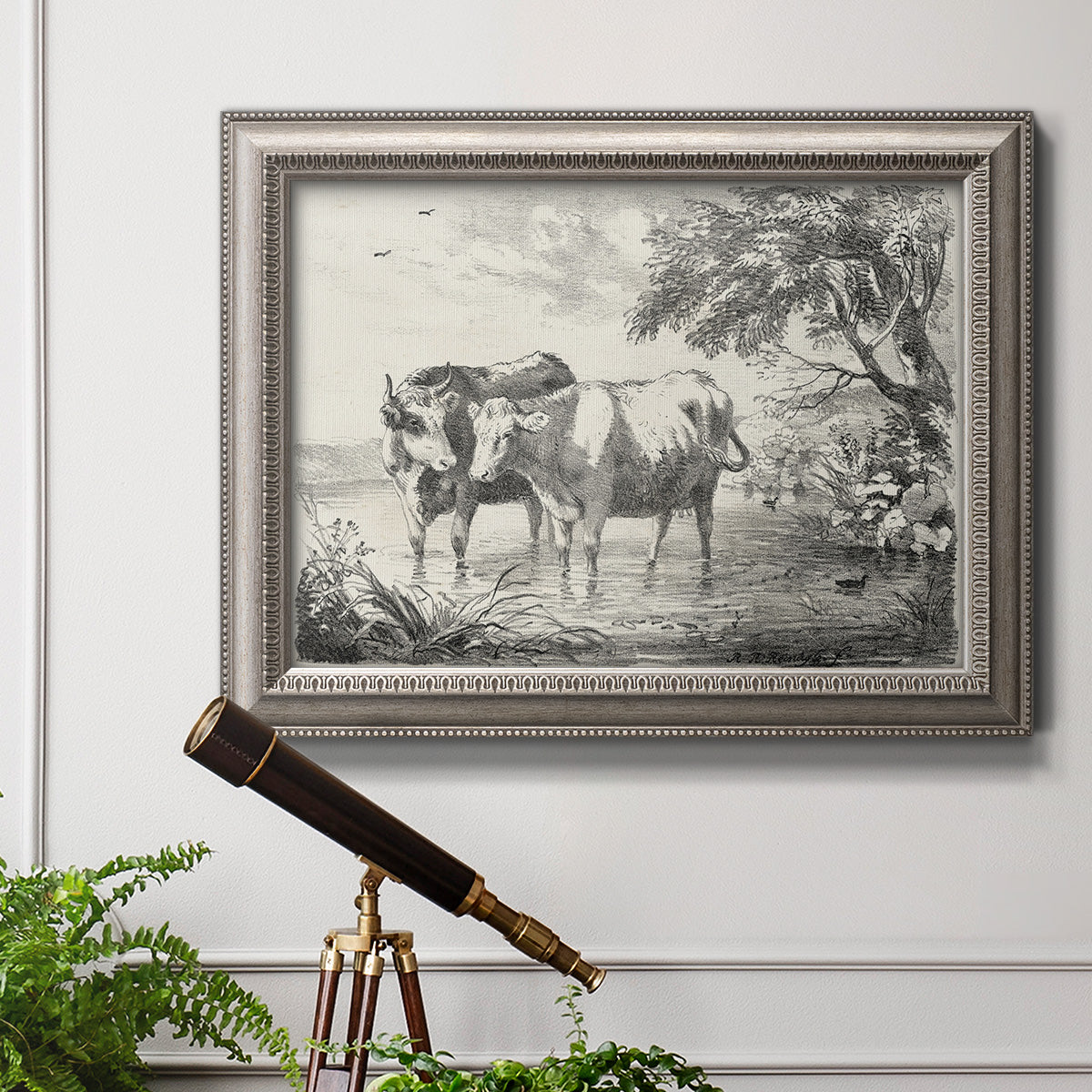 Classical countryside landscape artwork by Nicolas Berchem in an ornate vintage silver frame displayed in a light-toned interior setting.