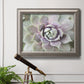 Soft abstract floral botanical photography in an ornate vintage silver frame displayed in a light-toned interior setting.