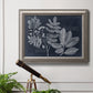 Antique botanical foliage artwork on navy background in an ornate vintage silver frame displayed in a light-toned interior setting.