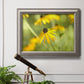 Contemporary black-eyed Susan flower photography in an ornate vintage silver frame displayed in a light-toned interior setting.