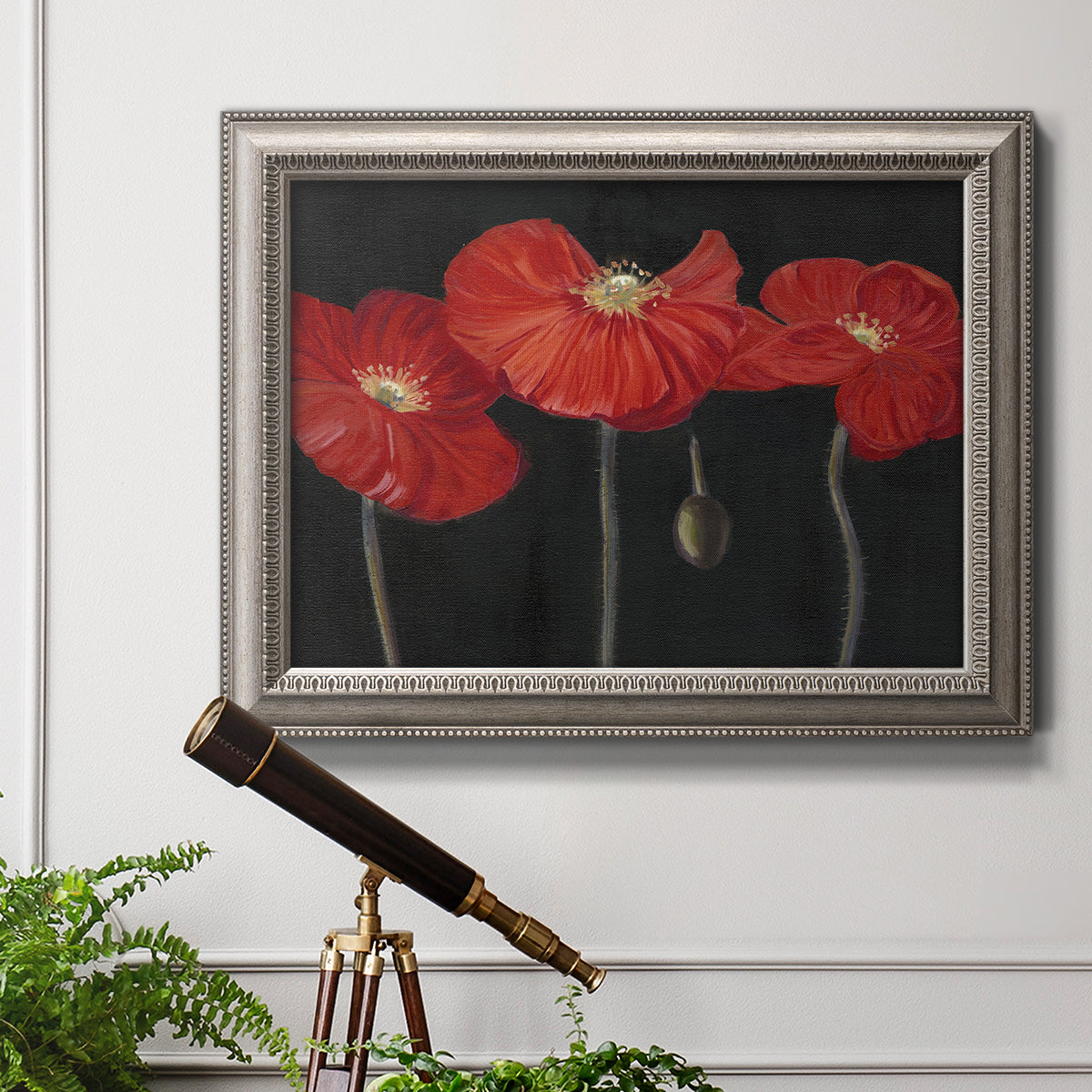 Modern red poppy floral artwork in an ornate vintage silver frame displayed in a light-toned interior setting.