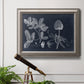 Antique botanical foliage illustration on navy background in an ornate vintage silver frame displayed in a light-toned interior setting.