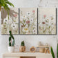 Three-panel canvas wall art featuring loose farmhouse style floral painting, displayed in a boho-chic entryway above a console table.