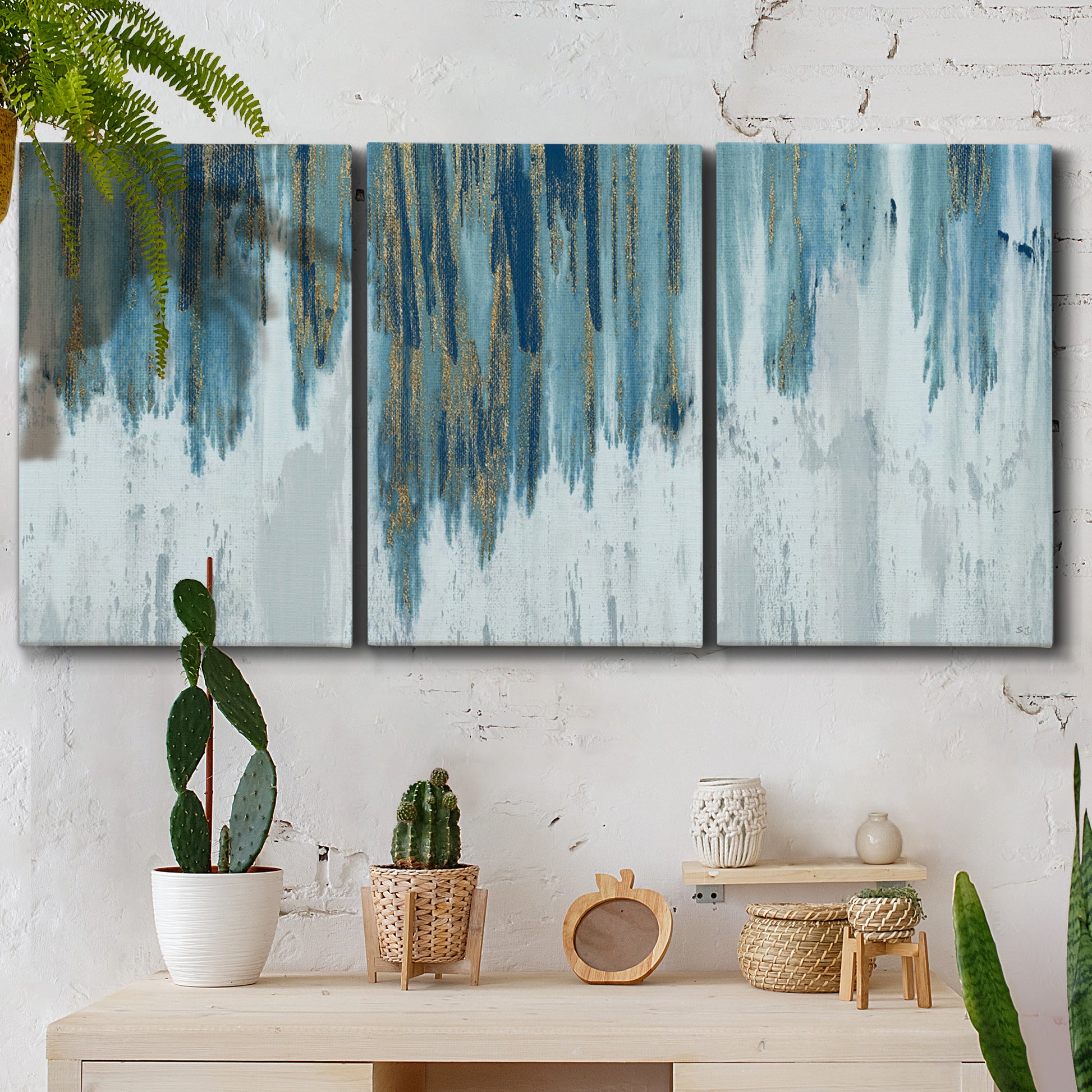 Three-panel canvas wall art featuring wide pastoral valley landscape, displayed in a boho-chic entryway above a console table.