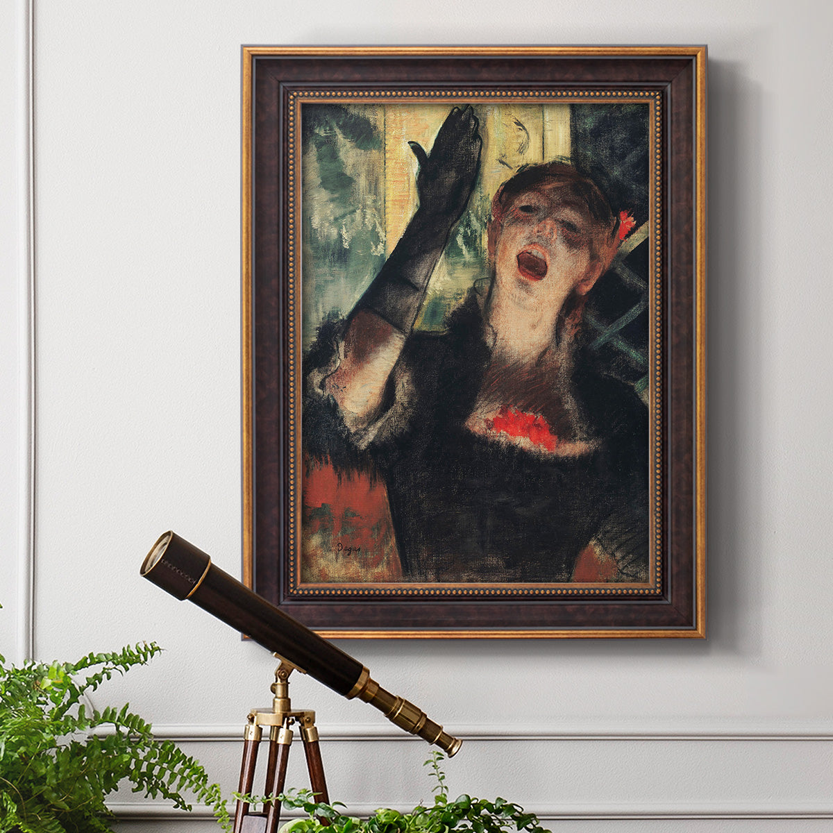 Impressionist portrait of a café singer by Edgar Degas in an ornate bronzed mahogany wood frame displayed in a light-toned interior setting.