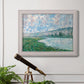 Impressionist river landscape at Vétheuil by Claude Monet in an ornate weathered white frame displayed in a light-toned interior setting.