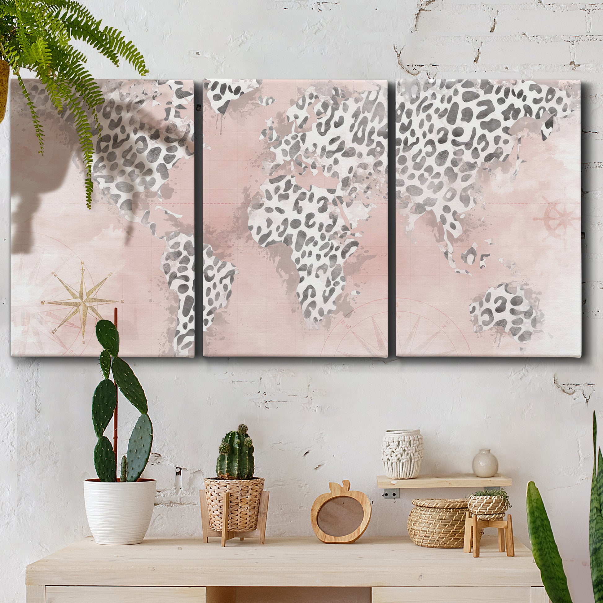 Three-panel canvas wall art featuring stylized pink cheetah world map, displayed in a boho-chic entryway above a console table.