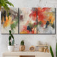 Three-panel canvas wall art featuring abstract floral color composition, displayed in a boho-chic entryway above a console table.