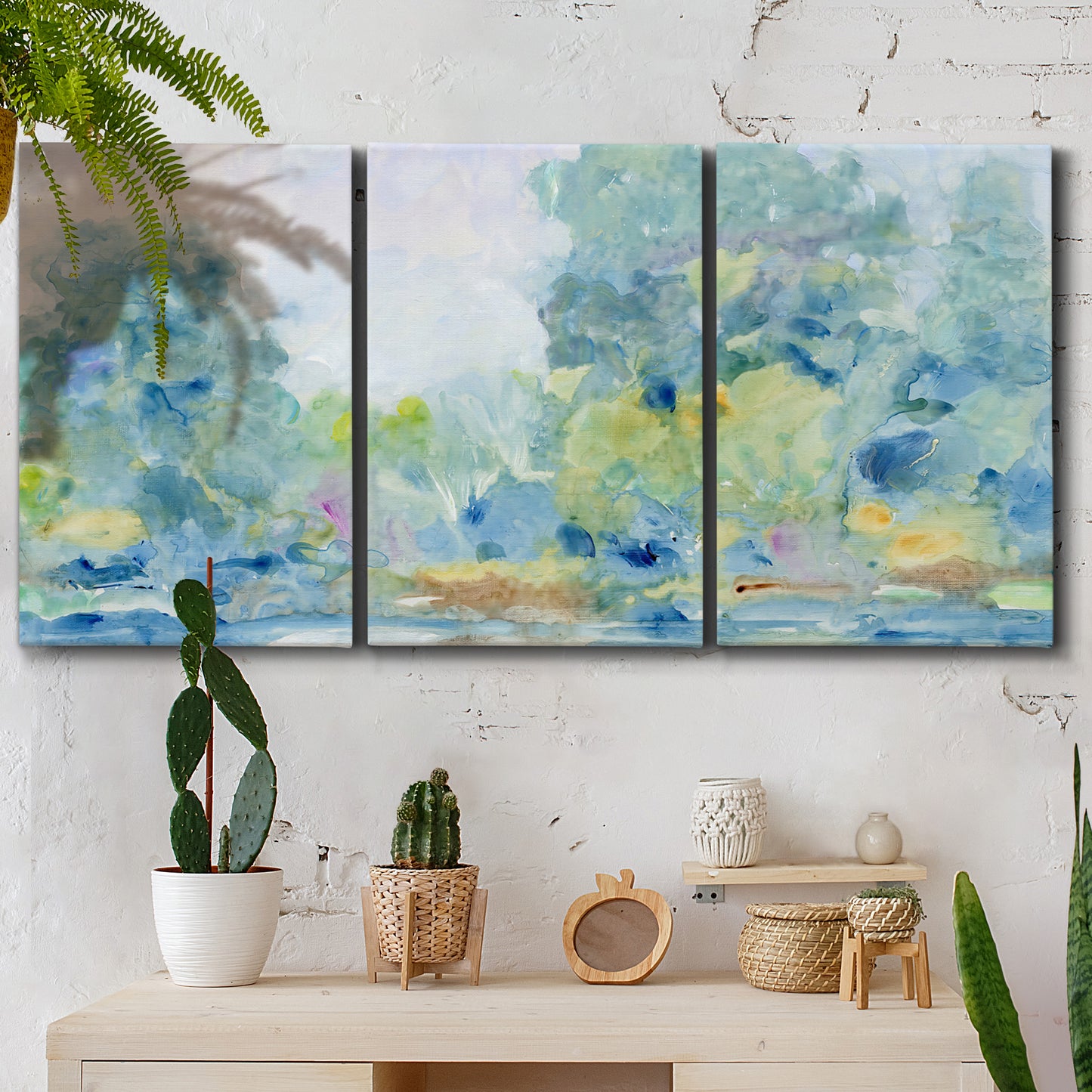 Three-panel canvas wall art featuring quiet abstract morning landscape, displayed in a boho-chic entryway above a console table.