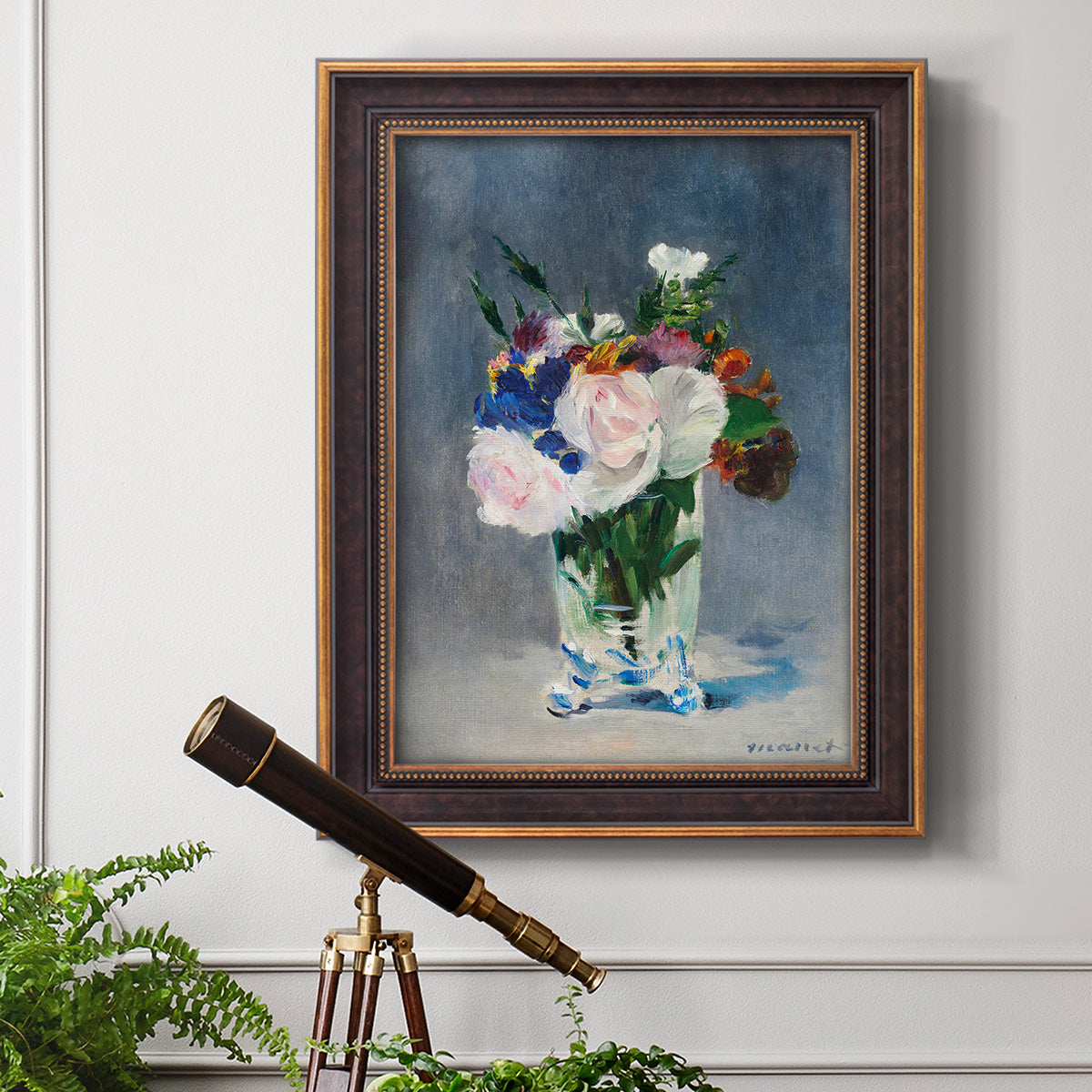 Impressionist floral still life painting by Claude Monet in an ornate bronzed mahogany wood frame displayed in a light-toned interior setting.
