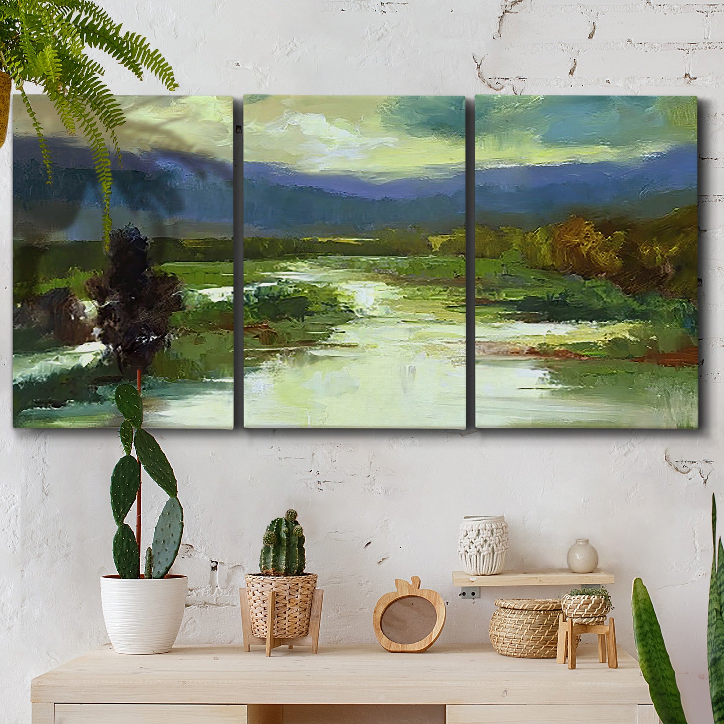 Three-panel canvas wall art featuring open meadow landscape with distant hills, displayed in a boho-chic entryway above a console table.