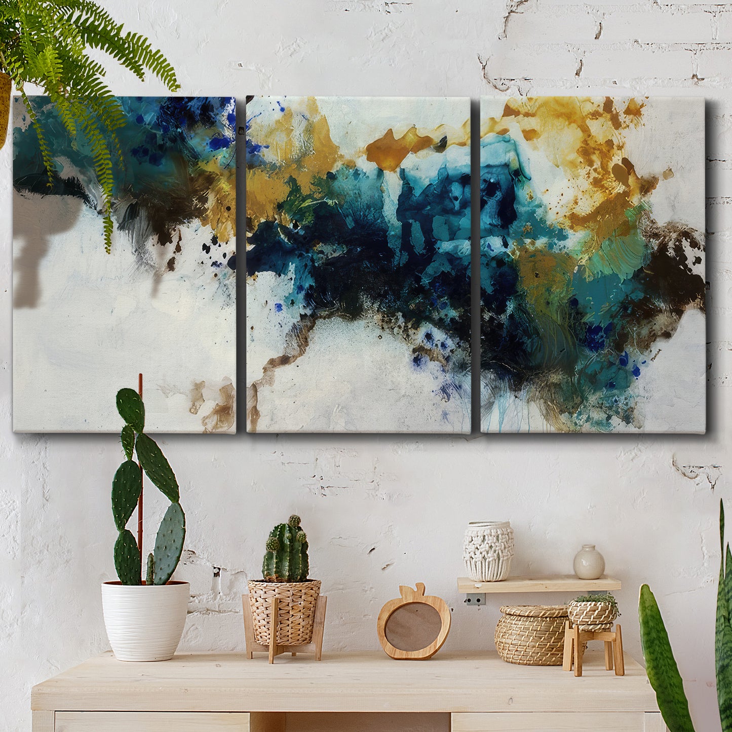 Three-panel canvas wall art featuring teal abstract paint splatter, displayed in a boho-chic entryway above a console table.