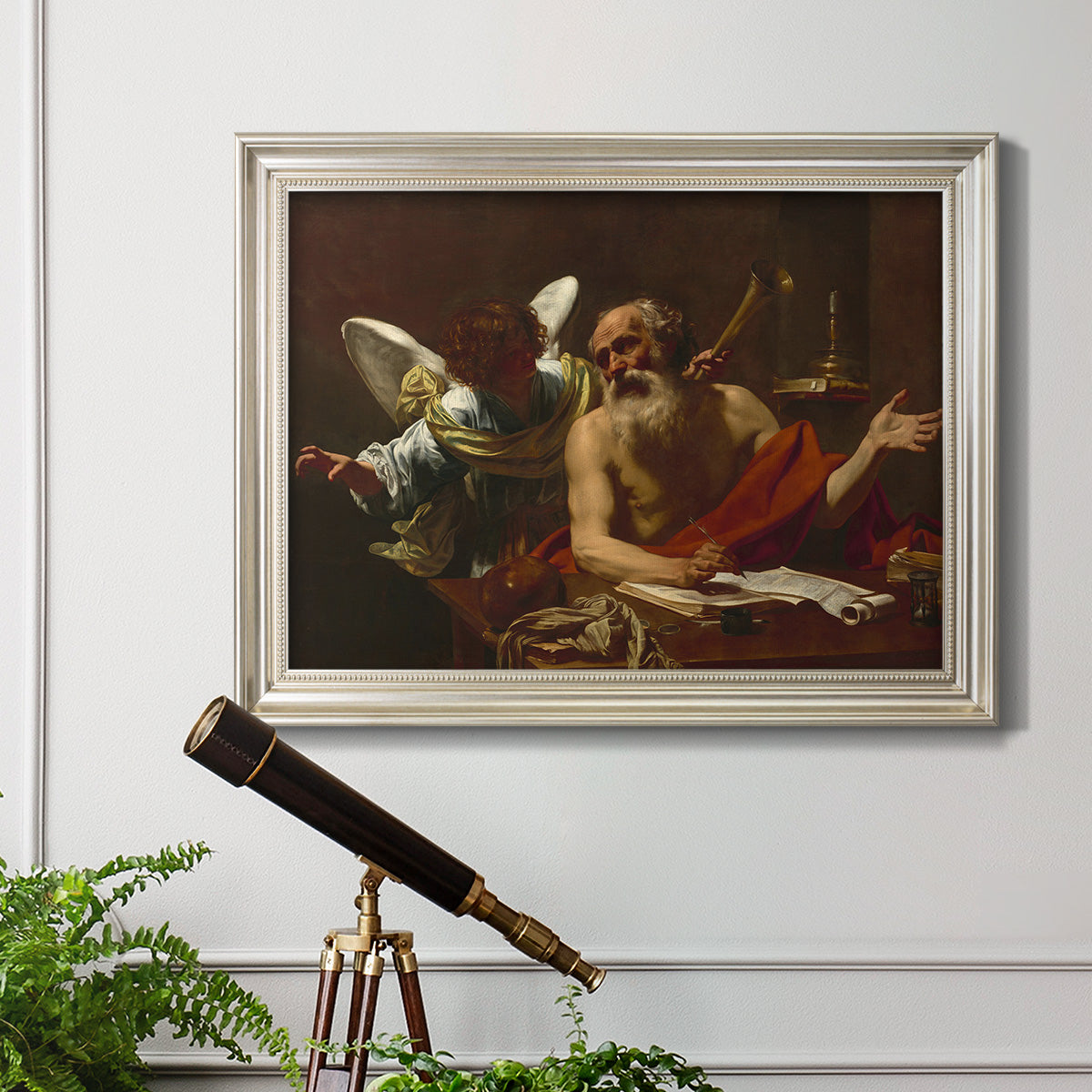 Classical religious painting of Saint Jerome with an angel by Simon Vouet in an ornate champagne frame displayed in a light-toned interior setting.