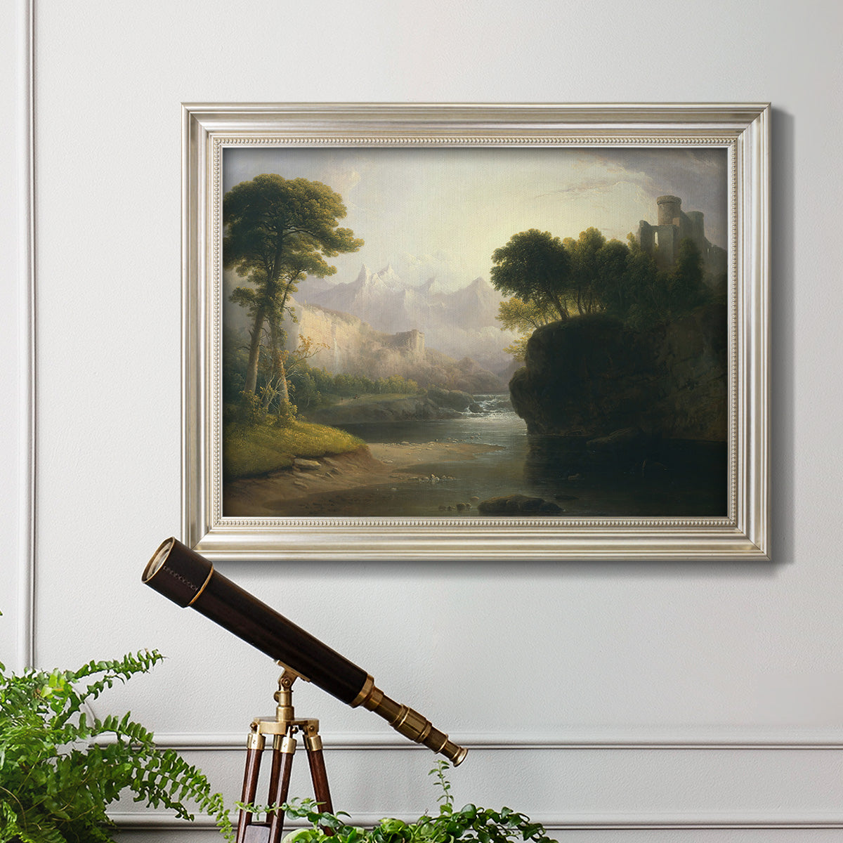 Romantic autumn landscape along the Hudson River by Thomas Doughty in an ornate champagne frame displayed in a light-toned interior setting.
