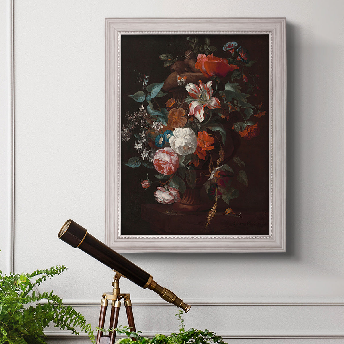 Classical floral still life painting by Jan van Huysum in an ornate weathered white frame displayed in a light-toned interior setting.