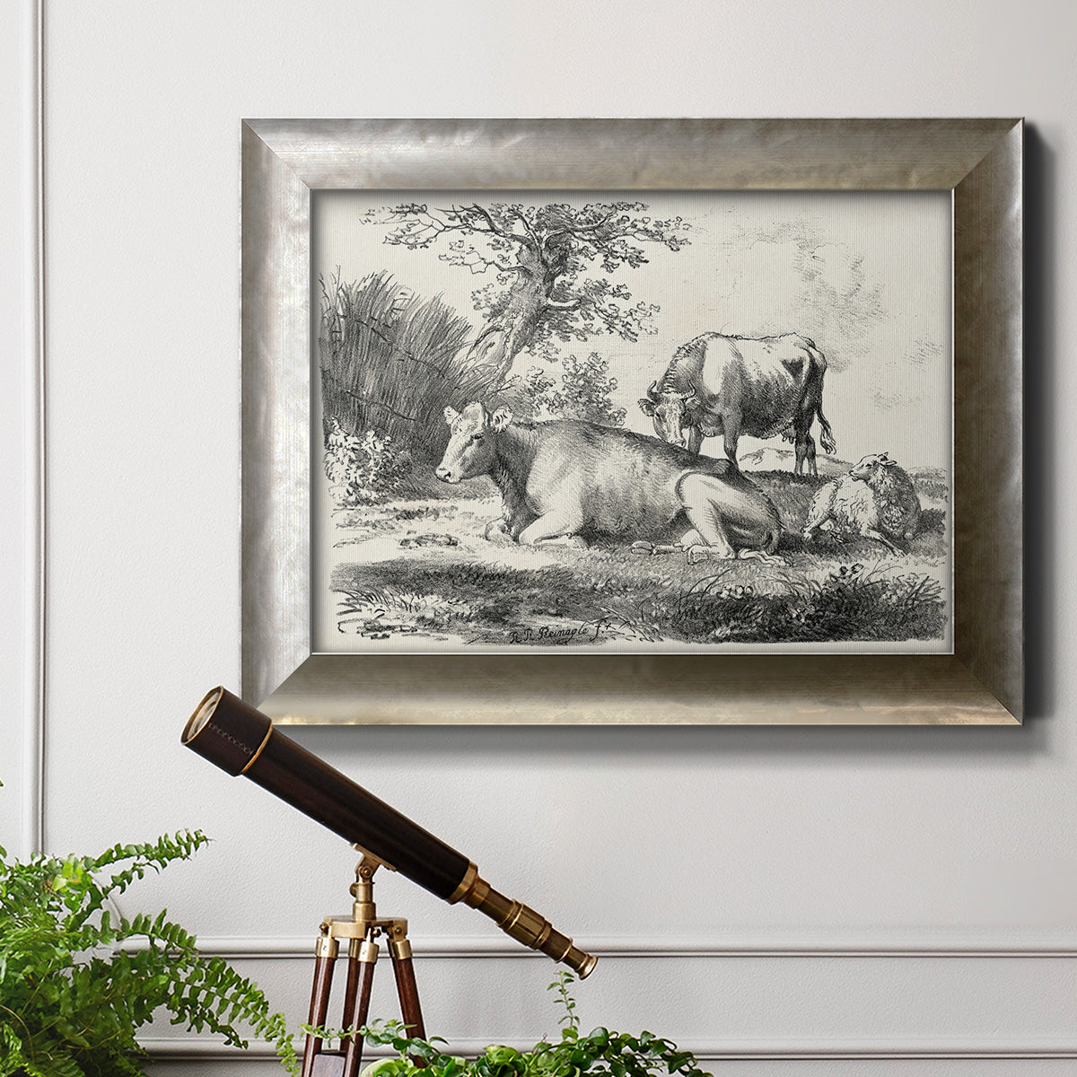 Classical pastoral landscape artwork by Nicolas Berchem in an ornate mottled silver frame displayed in a light-toned interior setting.