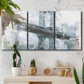 Three-panel canvas wall art featuring urban cityscape with architectural forms, displayed in a boho-chic entryway above a console table.