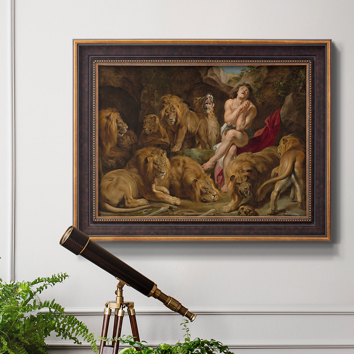 Dramatic biblical painting of Daniel with lions by Peter Paul Rubens in an ornate bronzed mahogany wood frame displayed in a light-toned interior setting.