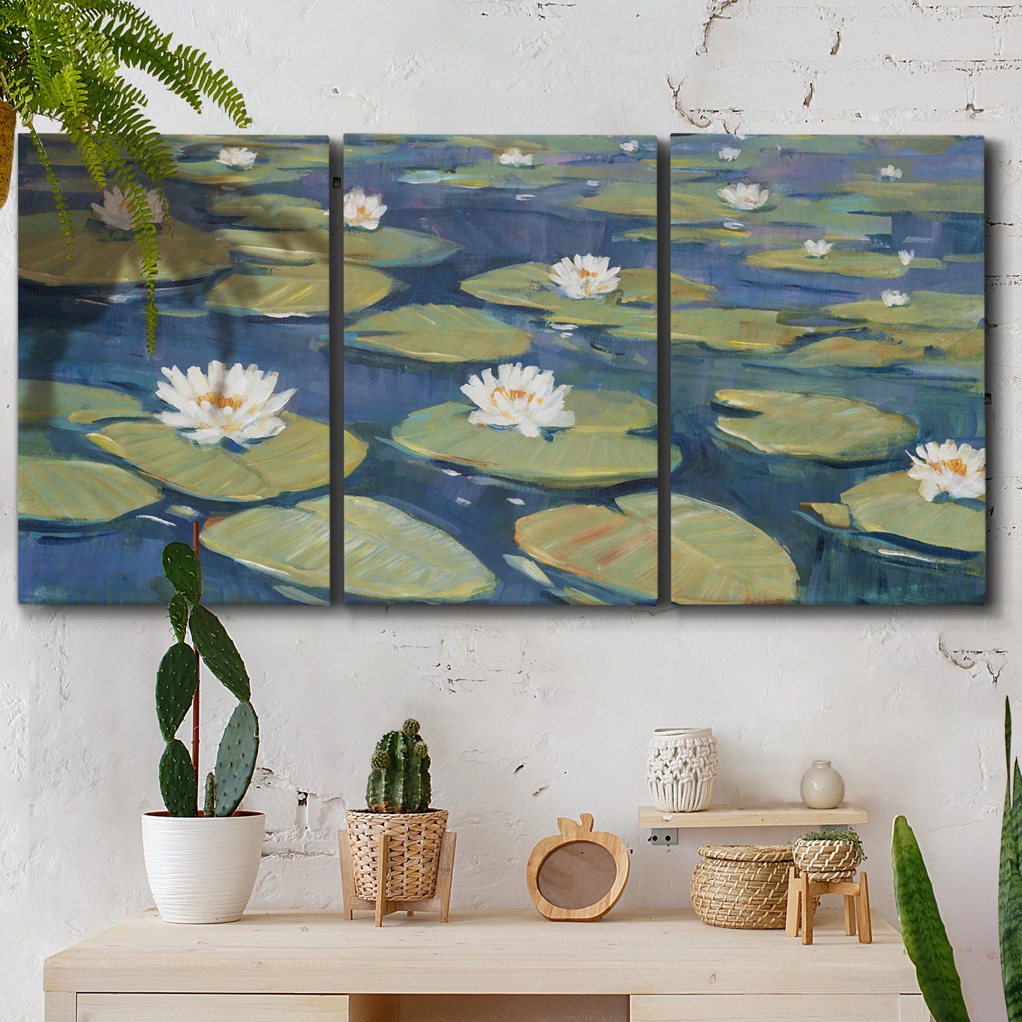 Three-panel canvas wall art featuring water lilies floating on pond, displayed in a boho-chic entryway above a console table.