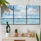 Three-panel canvas wall art featuring tropical clouds over ocean horizon, displayed in a boho-chic entryway above a console table.