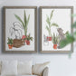 Set of two gray barnwood framed canvas prints depicting curious felines, terracotta pots, succulents, and leafy stems arranged across two complementary compositions above a sofa in a bright living space.