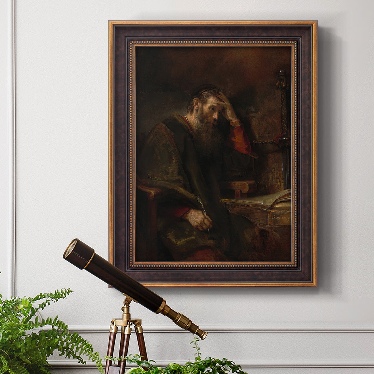 Classical religious portrait of Paul the Apostle by Rembrandt van Rijn in an ornate bronzed mahogany wood frame displayed in a light-toned interior setting.