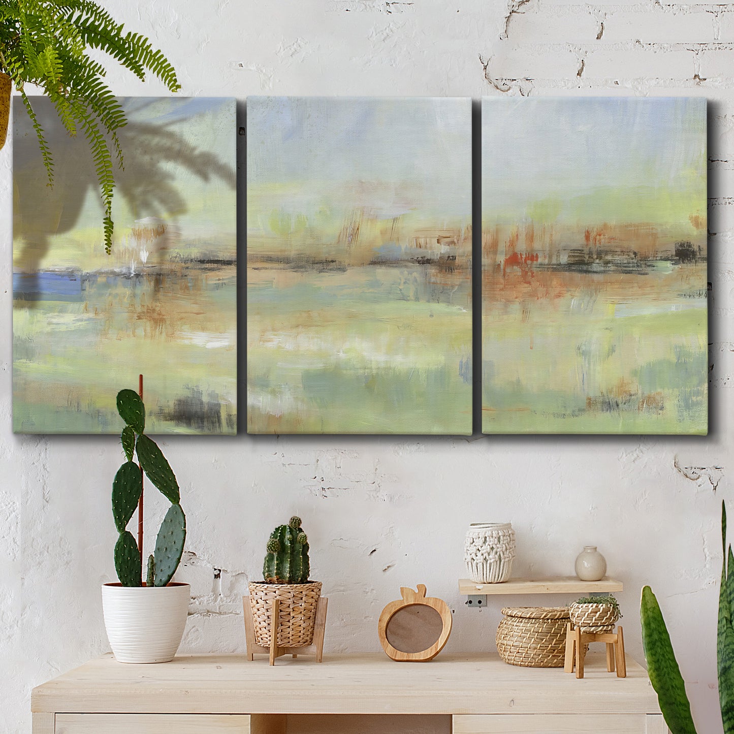 Three-panel canvas wall art featuring layered abstract transitional textures, displayed in a boho-chic entryway above a console table.