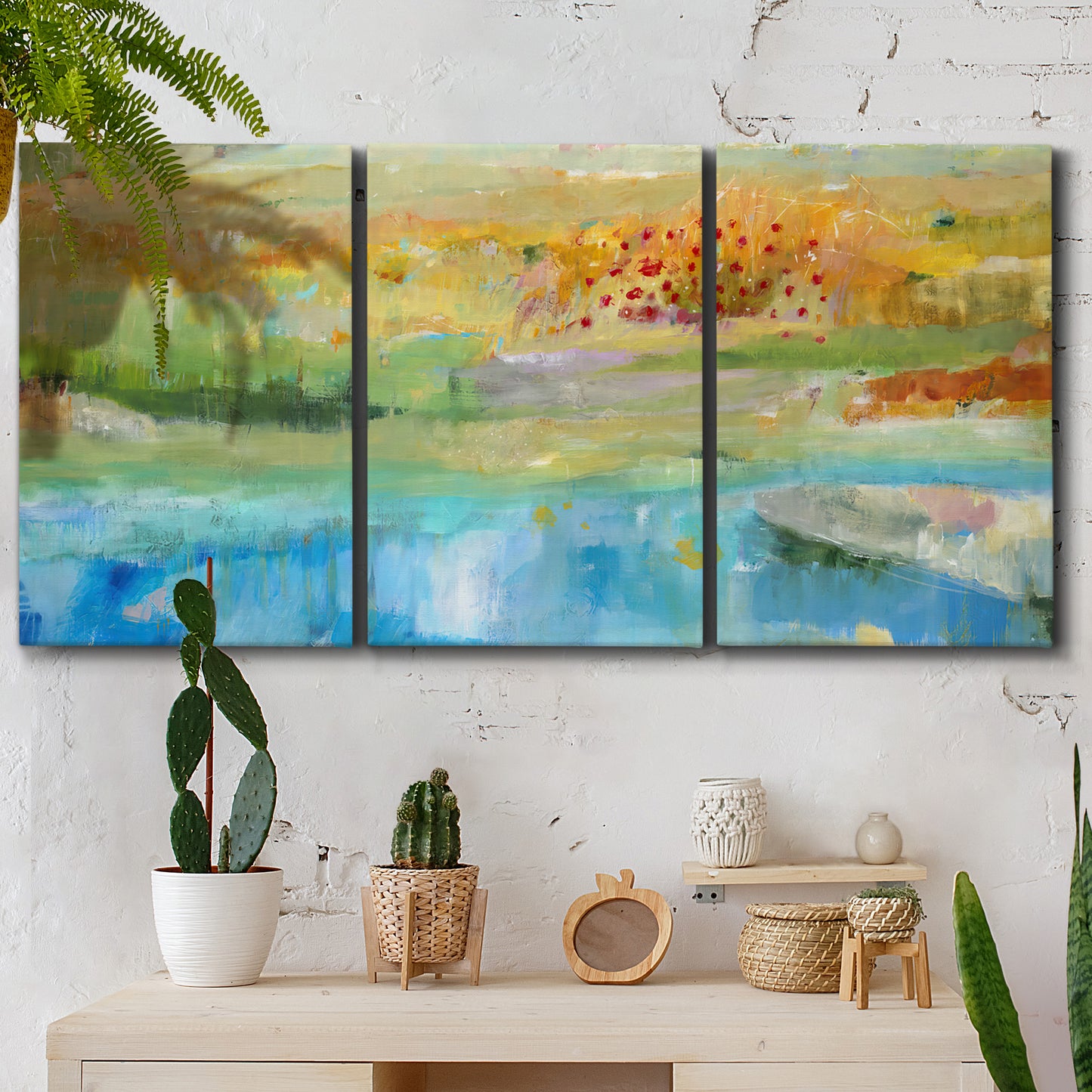 Three-panel canvas wall art featuring abstract sense of forward movement, displayed in a boho-chic entryway above a console table.