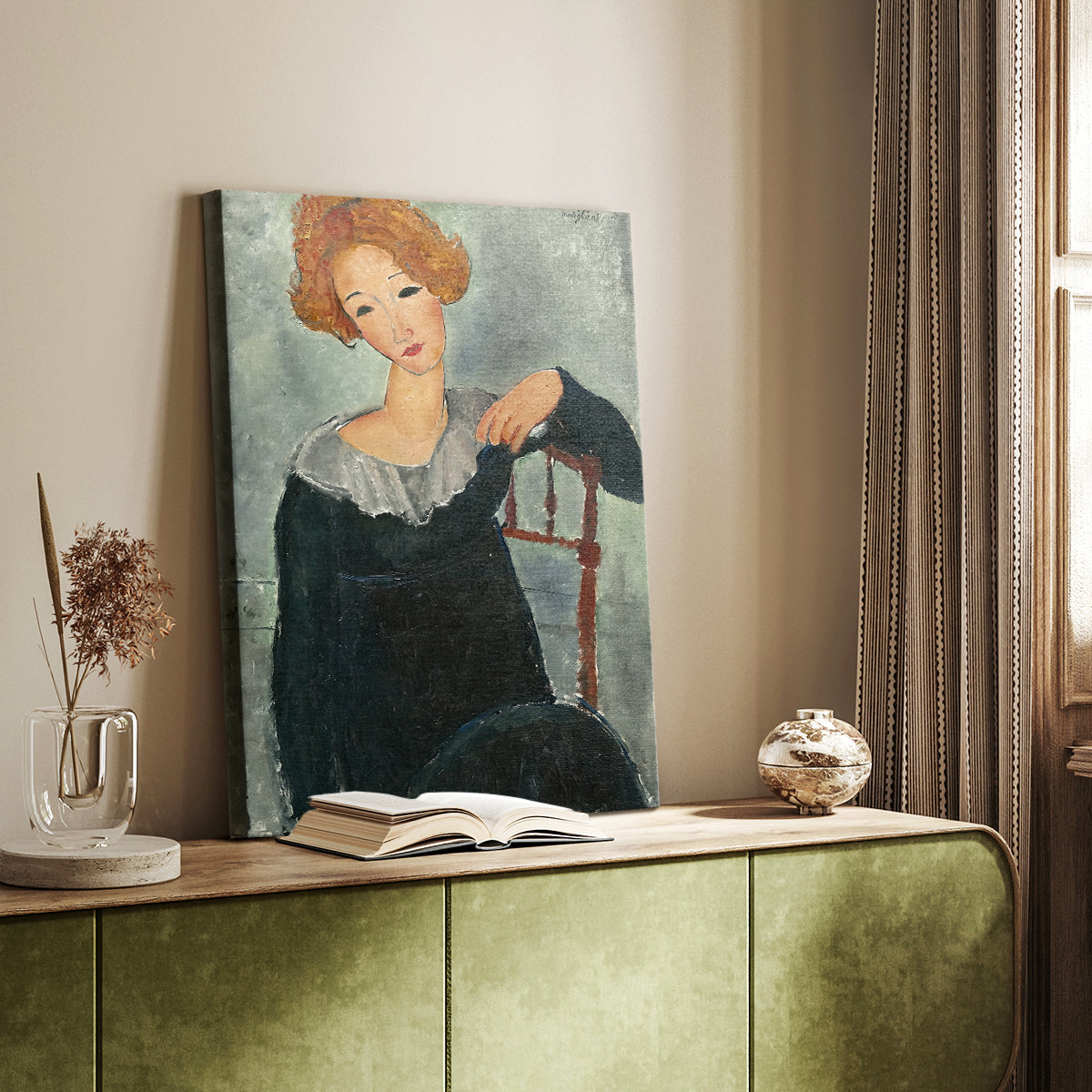 Canvas art print of a stylized portrait with simplified facial features and warm tones styled in a home decor setting.