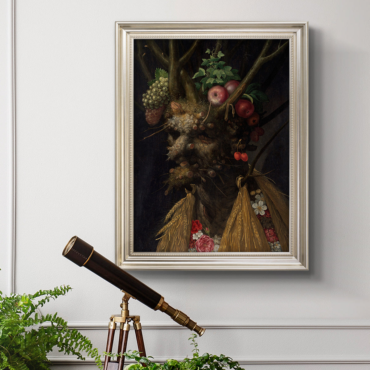 Surreal allegorical portrait representing the four seasons by Giuseppe Arcimboldo in an ornate champagne frame displayed in a light-toned interior setting.