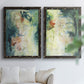 Set of two black barnwood framed canvas prints depicting vertical organic marks, pale light passages, and weathered surfaces arranged across two complementary compositions above a sofa in a bright living space.