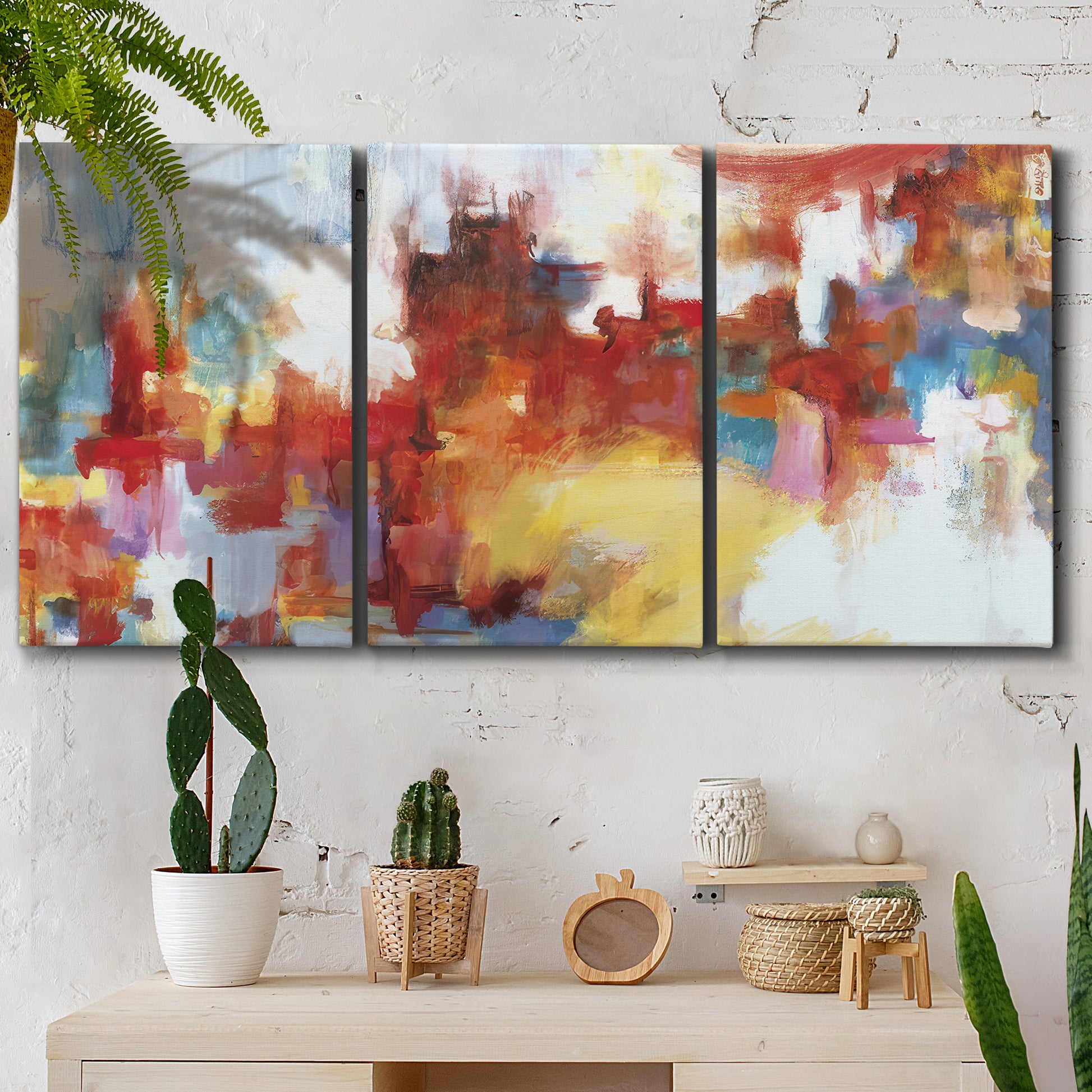 Three-panel canvas wall art featuring abstract city lights composition, displayed in a boho-chic entryway above a console table.
