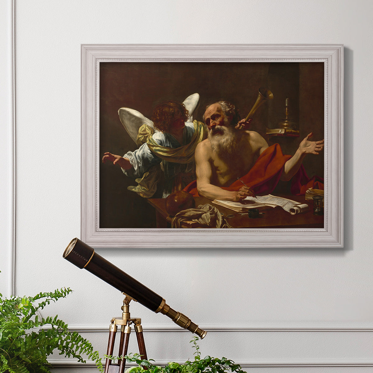 Classical religious painting of Saint Jerome with an angel by Simon Vouet in an ornate weathered white frame displayed in a light-toned interior setting.