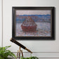 Impressionist single haystack landscape by Claude Monet in an ornate black frame with gilded inner detail displayed in a light-toned interior setting.
