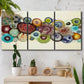 Three-panel canvas wall art featuring mid century geometric red pathway, displayed in a boho-chic entryway above a console table.