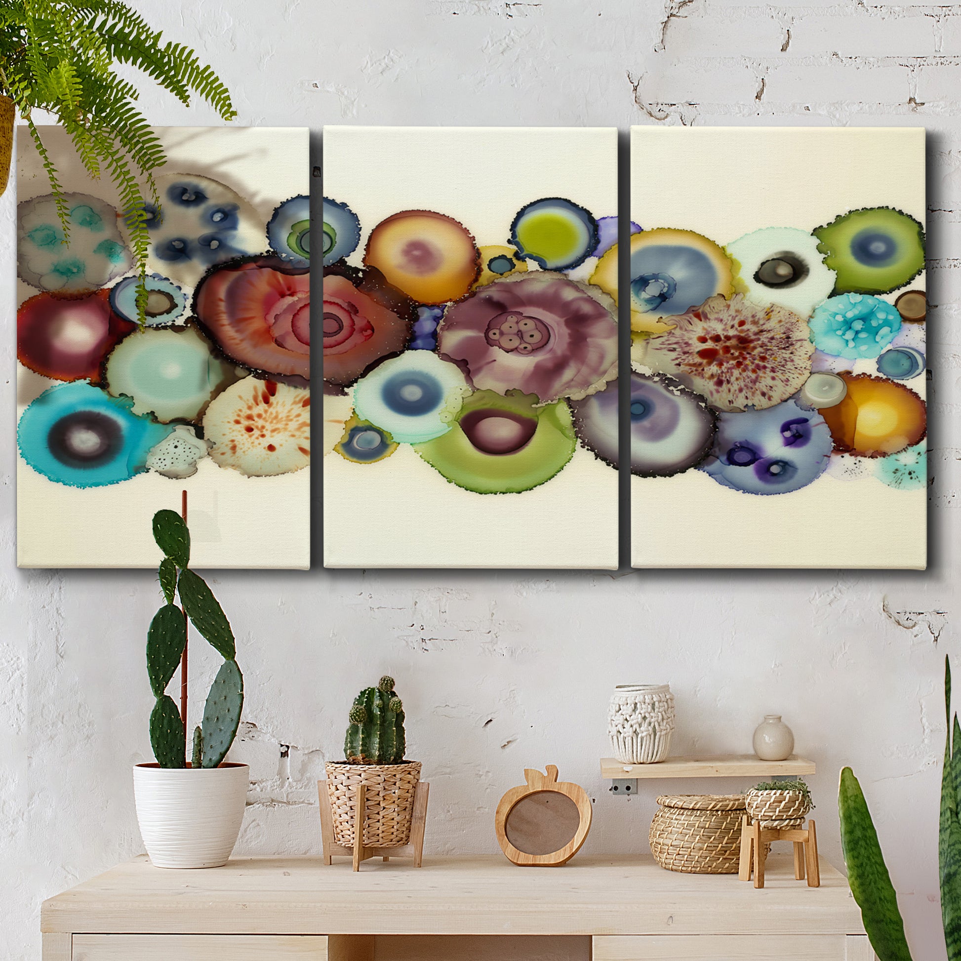 Three-panel canvas wall art featuring mid century geometric red pathway, displayed in a boho-chic entryway above a console table.