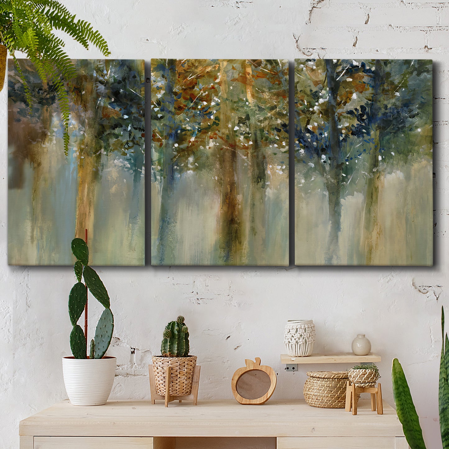 Three-panel canvas wall art featuring earth toned abstract leaf textures, displayed in a boho-chic entryway above a console table.