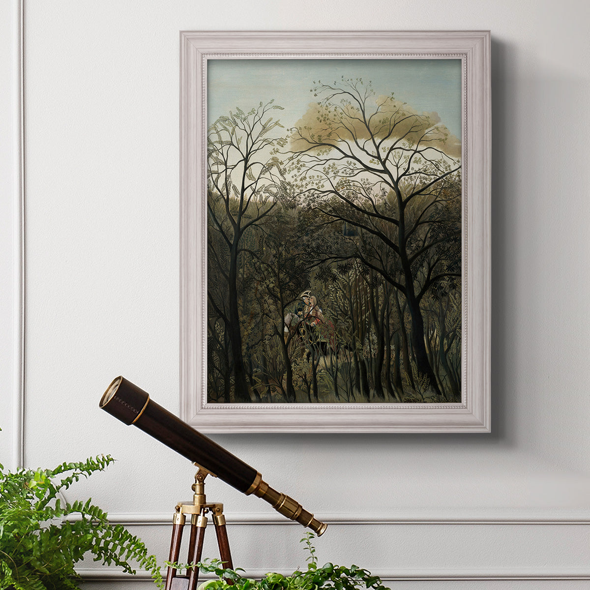 Dreamlike forest landscape scene by Henri Rousseau in an ornate weathered white frame displayed in a light-toned interior setting.